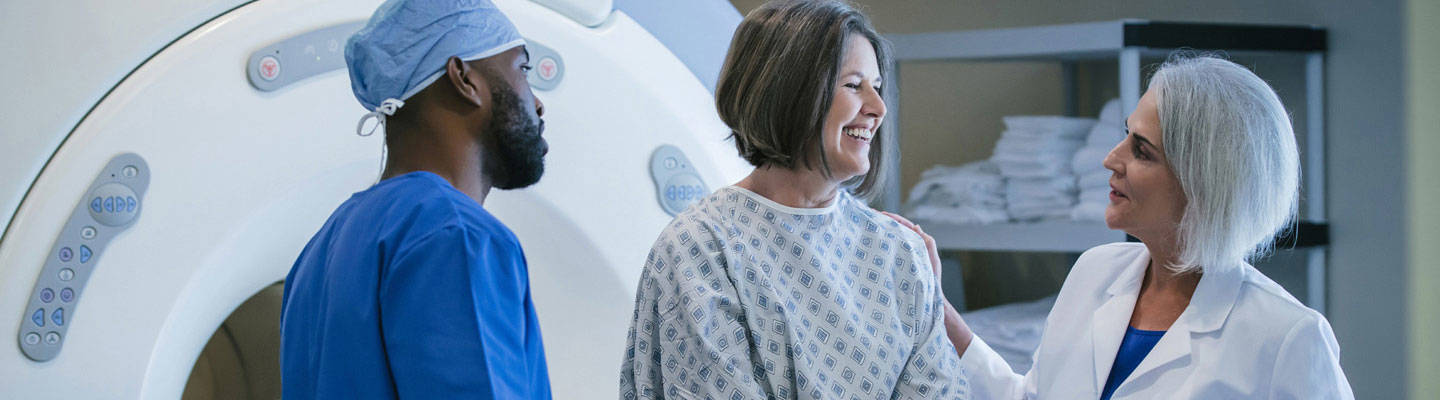 A woman prepares to have an MRI scan.